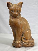 Full front view of the cast stone cat sculpture showing entire figure including base.