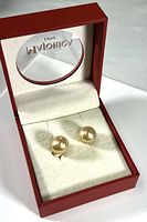 View of earrings inside the red Majorica branded gift box showing the presentation arrangement and condition