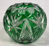 Front side view of the green overlay crystal vase showing star cuts and lattice pattern