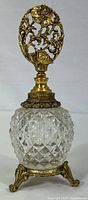 Full view of vintage Matson perfume bottle showing cut glass body and ornate metal stopper and base