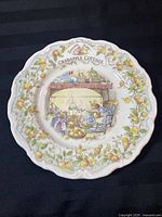 Full view of the Royal Doulton collector plate titled 'Crabapple Cottage' from Brambly Hedge series, showing the detailed interior scene of mice in kitchen and the crabapple border design.