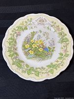 Full view of the plate showing floral border, central mouse artwork, and text 'Brambly Hedge SPRING'