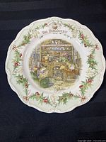 Full front view of the Royal Doulton Brambly Hedge 'The Discovery' collector plate showing central illustration and decorative holly and berry border.