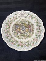 Full view of the collector plate showing floral rim and central illustration of two mice at window with flowers, titled 'The Invitation'.