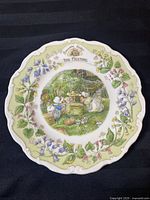 Top view of a Brambly Hedge collector plate titled 'The Meeting' showing detailed illustration of mice in a woodland setting with a floral border.