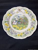 Front view of one collector plate showing central mice illustration and floral border