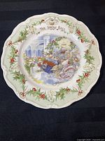 Full view of the Royal Doulton Brambly Hedge 'The Snow Ball' collector plate showing central winter scene and border holly decoration.
