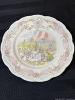 Full top view of the collector plate showing the wedding scene illustration and floral border