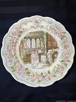 Full view of the Royal Doulton collector plate 'The Dairy' with Brambly Hedge illustration in center and floral border.