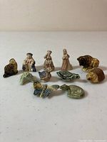 Photo showing all 11 Wade Whimsies figurines arranged in two rows, variety of animals and human figures visible.