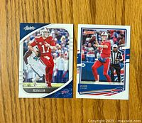 Two Josh Allen football cards on wooden surface, one Panini Absolute and one Donruss card.