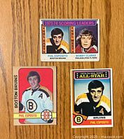 Front view of three hockey cards featuring Phil Esposito and Bobby Clarke, showing players in team uniforms and card titles.
