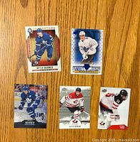 Front view of all 5 Mitch Marner hockey cards in different designs and uniforms; Toronto Maple Leafs and Team Canada represented.
