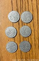 Six 1935 Canada five cent nickels showing reverse side with denomination and maple leaf design.