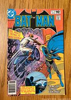 Front cover of Batman #326 comic book showing Batman and a motorcycle attacker crashing through a fence.