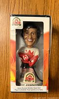 Front view of the boxed Phil Esposito bobblehead figurine wearing 1972 Team Canada uniform with maple leaf emblem.