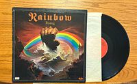 Front cover of Rainbow Rising vinyl album, showing detailed colorful artwork and title.