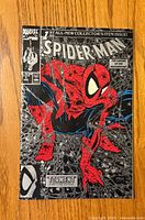 Front cover showing Spider-Man crouching in red and black suit among webs on Spider-Man #1 comic book by Marvel Comics