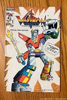 Front cover of Voltron #1 comic book featuring the robot with weapons and logo.