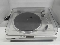 Full front view of the Sony PS-T15 turntable with dust cover closed, showing the overall device condition and layout.