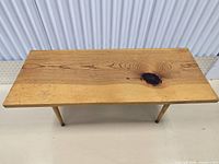 Top view of the vintage wooden coffee table showing the full tabletop with natural wood grain and knot features.