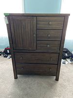 Front view of highboy chest showing five drawers and one door
