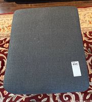 Top view showing the flat cushioned grey fabric surface and a MaxSold lot tag