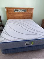 Assembled queen bed set showing headboard, mattress and box spring