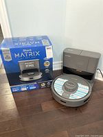 Shark Matrix robot vacuum with self-empty base station and original box displayed