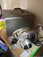 Porter-Cable circular saw and metal carrying case on plywood surface.