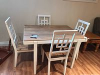 Full view of rectangular table and four matching chairs in two-tone finish