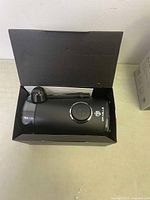 Black Dr Mills coffee grinder in open black box with scoop included