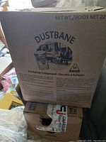 Photo of the front of the Dustbane box showing label with product name and details.