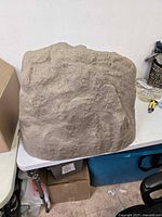 Top view showing the textured sandstone-like exterior surface of the large resin landscape rock.