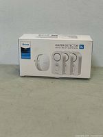 Front view of the Govee Water Detector box showing product image featuring one Wi-Fi gateway and three water detector sensors.