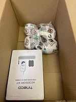 Box with Tigerco Accessory Kit and a bear-pattern cushioning item