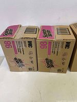 Two unopened cardboard boxes of 3M Scotch-Brite 98 medium duty scouring pads showing front and top labels with branding and product info.