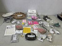 Wide view of miscellaneous women's accessories including cotton tissues, hair clips, hair sticks, earrings, and other small items spread on a flat surface.