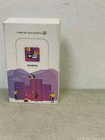 Front view of Muama portable 4G WiFi router box with colorful cityscape and WiFi branding