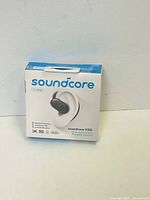 Front of the box showing Soundcore V20i earbuds with branding and product image.