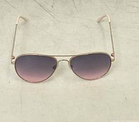 Front view of aviator sunglasses showing gradient lenses and gold-tone frame