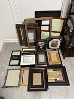 Full view of all picture frames arranged on the floor, showing variety of styles and colors