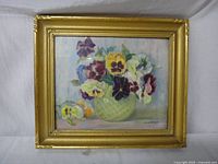 Full front view of the framed painting showing pansies in a green vase, bright and colorful oil painting.