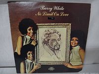 Front cover of the Barry White 'No Limit On Love' vinyl album featuring three women holding a framed sketch portrait of Barry White.