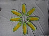 Top-down view showing all six corn cob plates arranged in a circle.