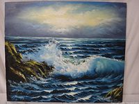 Full front view of the ocean scene painting on canvas, showing waves breaking on rocks under cloudy sky.