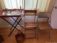 Wide shot showing full lot with tray table, jewelry items on table, two folding chairs and copper bucket on floor