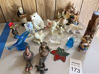 Overview photo of various decorative animal and holiday figurines showcasing glass, wood, and porcelain materials.
