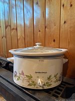 Slow cooker showing floral pattern and control knob