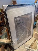 Full view of the IKEA Ribba picture frame sealed in plastic wrap.